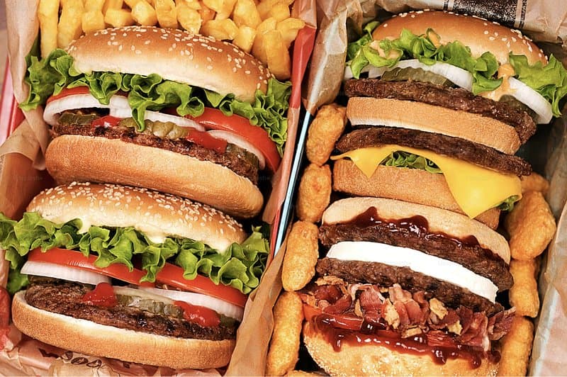 Stacked burgers, fries and nuggets from chain restaurants